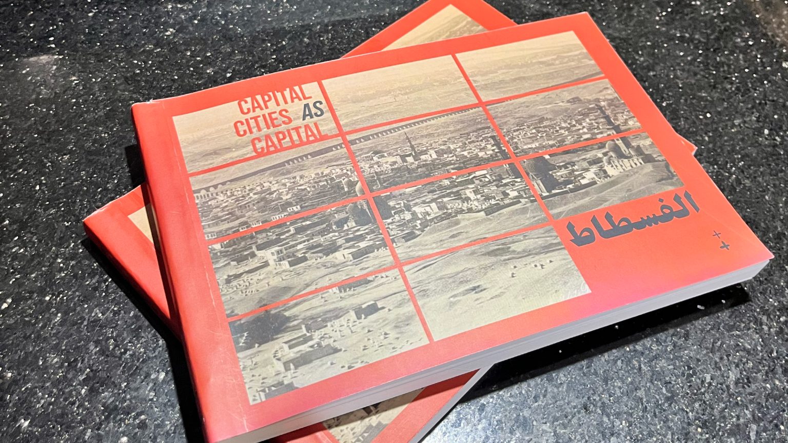 Two copies of the book al-Fustat: Capital Cities as Capital on a dark surface