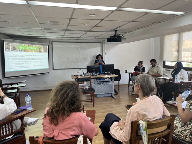 Participants listen to a presentation in a seminar room during the Experimenting with Urbanity workshop