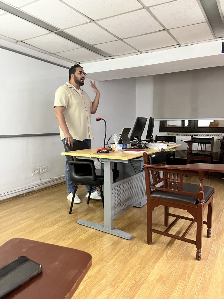 A speaker stands at the front of the seminar room during the Experimenting with Urbanity workshop